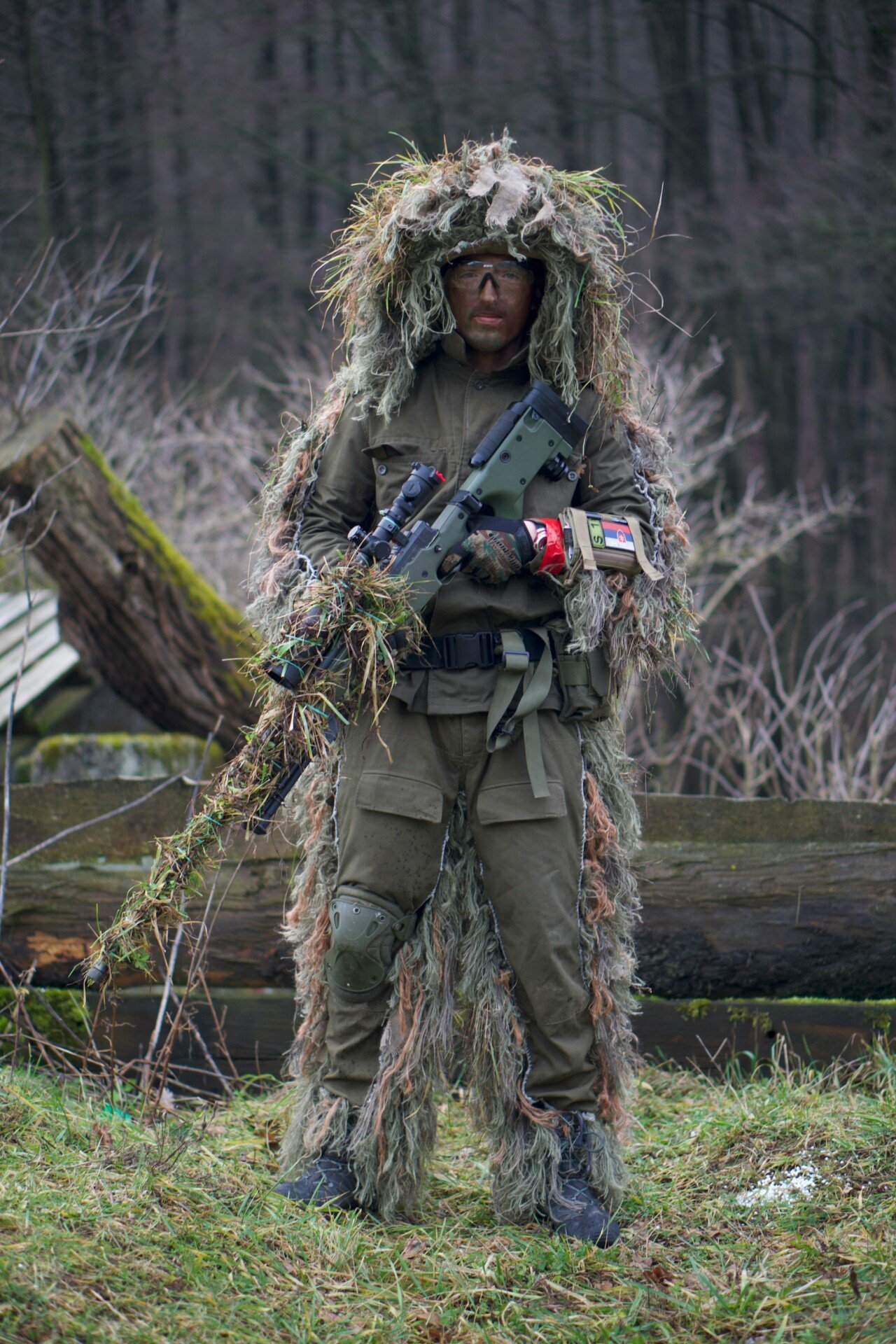 soldier covered with grass holding sniper rifle